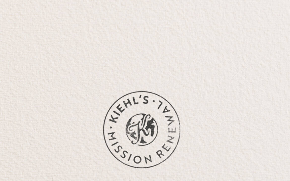  Kiehl’s Mission Renewal banner featuring a circular stamp logo and text reading, "Our imperfect journey to drive a more circular economy," promoting the brand's sustainability and circular economy initiative.